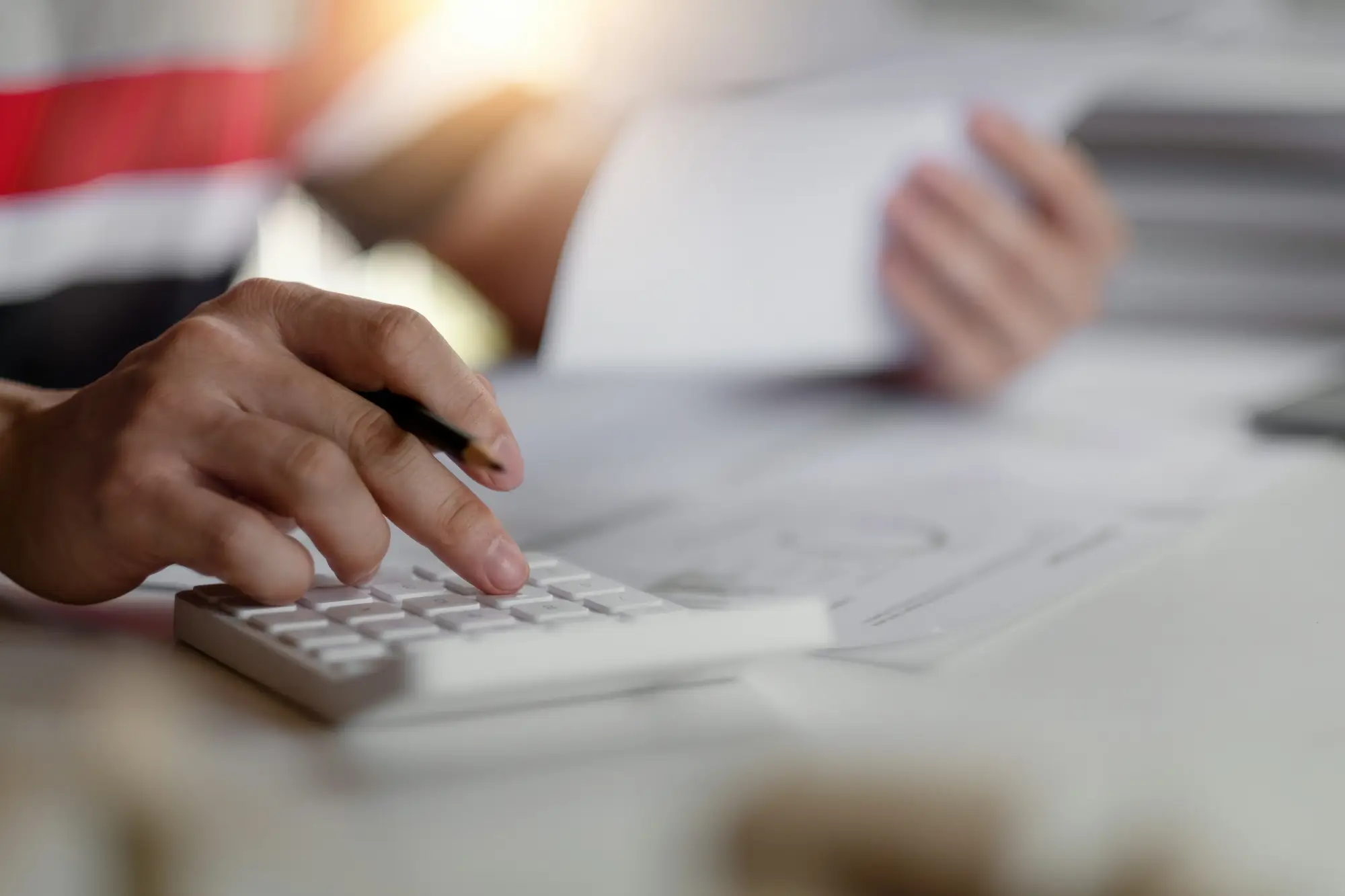 person typing on calculator